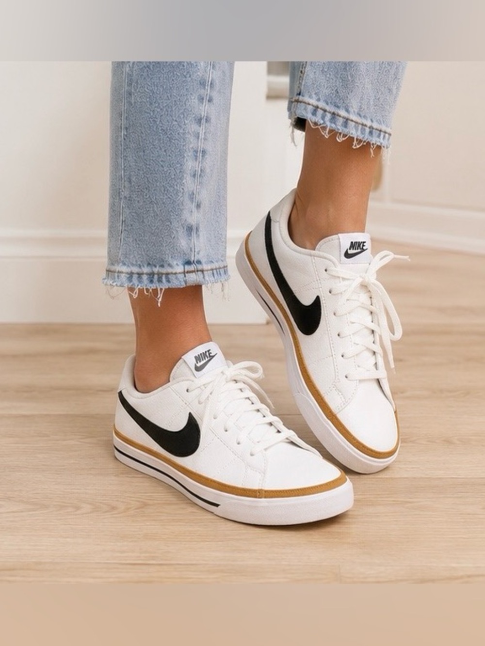 Nike White Low-Top Sneakers with Black Swoosh and Mustard Trim